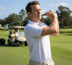 A model wearing the Performance Quick Dry Print Golf Polo plays golf on the course