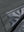 Close-up texture of dark grey waterproof lightweight rain jacket with hood fabric showing water-repellent weave detail.