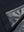 Close-up texture of navy waterproof lightweight rain jacket with hood fabric showing water-repellent weave detail.