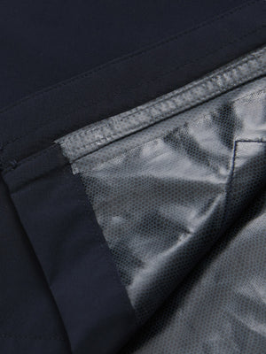 Close-up texture of navy waterproof lightweight rain jacket with hood fabric showing water-repellent weave detail.
