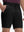 Front lower body shot of model wearing dark charcoal flat front hybrid golf shorts