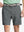 Front view of youth wearing dark grey Heather Performance Golf Shorts, showing fit and style