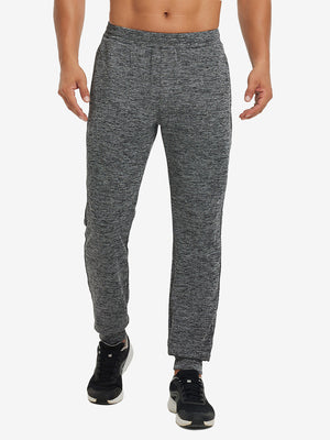 Front lower body view of model wearing soft sweatpants with 4 zipper pockets in black heather