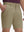 Front lower body shot of model wearing khaki flat front hybrid golf shorts