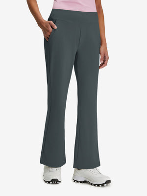 Front lower body shot of model wearing dark grey women's high waist stretch golf pants with pockets