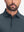 Front shot from nose to chest of model wearing dark grey dry fit waffle textured collared golf shirts