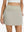 Front lower body shot of model wearing oyster gray women's stretch a-line golf skort with 7 pockets