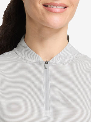 Front shot from nose to chest of model wearing light grey white women's q-zip pin striped texture golf shirts
