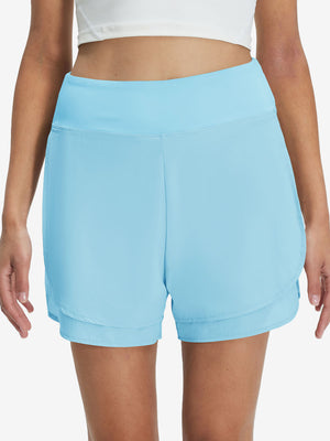 Front lower body shot of model wearing lake green women's gym golf shorts with liner pocket