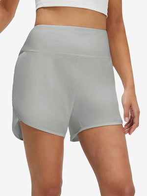 Front lower body shot of model wearing glacier grey women's high waist 2 in 1 quick dry shorts with 7 pockets