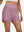 Front lower body shot of model wearing lavender pink women's high waist 2 in 1 quick dry shorts with 7 pockets
