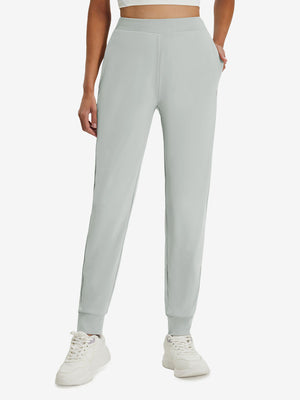 Front lower body shot of model wearing silver gray women's lightweight athletic sweatpants