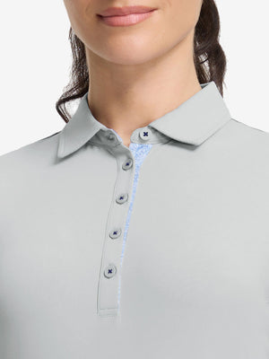 Front shot from nose to chest of model wearing light grey women's 5 buttons collared polo shirts