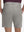 Back lower body shot of model wearing light gray flat front hybrid golf shorts