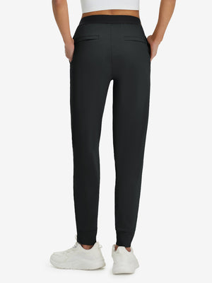 Back lower body shot of model wearing black women's lightweight athletic sweatpants