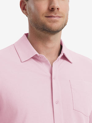 Model front view from nose to chest wearing pink cotton blend plain shirt.