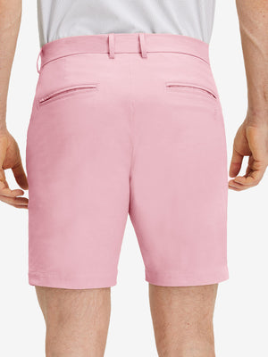 Back lower body shot of model wearing pink flat front flex cotton blend golf shorts