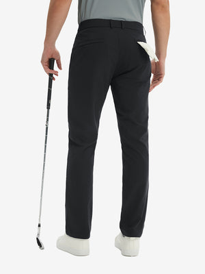 Rear lower-body: model in black stretch quick dry casual golf pants with 4 pockets holding golf club in right hand.