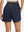 Back lower body shot of model wearing navy women's high waist 2 in 1 quick dry shorts with 7 pockets