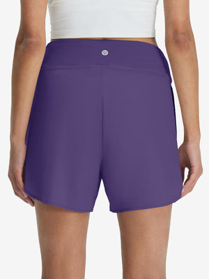 Back lower body shot of model wearing dark purple women's gym golf shorts with liner pocket