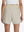 Back lower body shot of model wearing oyster gray women's gym golf shorts with liner pocket