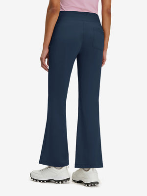 Back lower body shot of model wearing navy women's high waist stretch golf pants with pockets