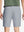 Back waist to knee view of grey water resistant golf 9 inch shorts, flexible performance fit.