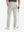 Rear lower-body: model in light khaki stretch quick dry casual golf pants with 4 pockets holding golf club in right hand.
