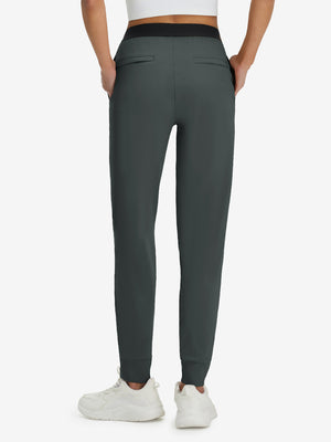 Back lower body shot of model wearing dark grey women's lightweight athletic sweatpants