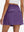 Back lower body shot of model wearing dark purple women's stretch a-line golf skort with 7 pockets