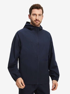 Front upper body shot of model wearing navy waterproof lightweight rain jacket with hood