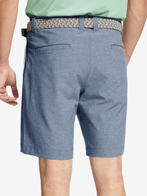 Back view of youth in dark blue Heather Performance Golf Shorts, highlighting rear design and fit