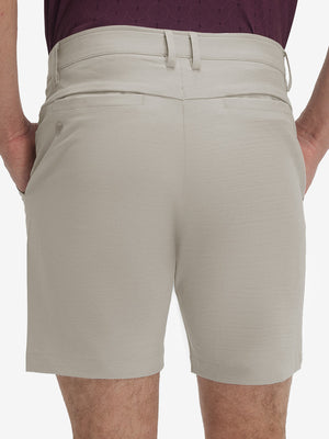 Back lower body shot of model wearing fossil flat front hybrid golf shorts