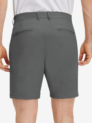 Back lower body shot of model wearing dark grey flat front flex cotton blend golf shorts
