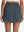Back lower body shot of model wearing dark grey high waist built-in short a-line golf skirt with 5 pockets