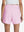 Back lower body shot of model wearing light pink women's gym golf shorts with liner pocket