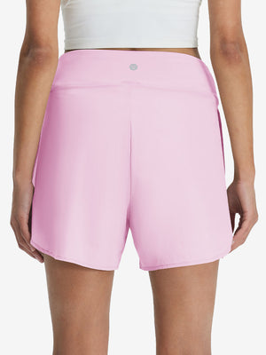 Back lower body shot of model wearing light pink women's gym golf shorts with liner pocket
