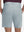 Back lower body shot of model wearing newport blue flat front hybrid golf shorts