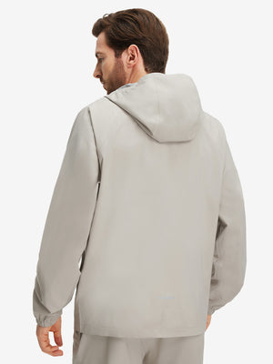 Back upper body shot of model wearing khaki grey waterproof lightweight rain jacket with hood