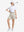 Front full body shot of model with golf gear wearing oyster gray women's moisture-wicking athletic tennis skirts