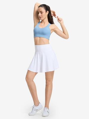 Front full body shot of model wearing white women's high waisted golf skirts with 4 inner pockets