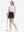 Front full body shot of model exercising in white blue florals women's sleeveless v-neck print golf shirts