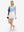 Front full body shot of model with golf gear wearing white women's stretch a-line golf skort with 7 pockets