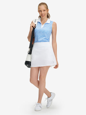Front full body shot of model with golf gear wearing white women's stretch a-line golf skort with 7 pockets