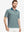 Front upper body shot of model wearing dark green oval premium ribbed collar print polo shirts