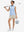 Front full body shot of model with golf gear wearing oyster gray women's gym golf shorts with liner pocket