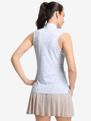 Back upper body shot of model wearing white blue florals women's sleeveless q-zip print quick dry golf tops