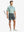 DARK GREY 4-way Stretch Performance Solid Shorts, golfer full-body front with club, 7 Inch length