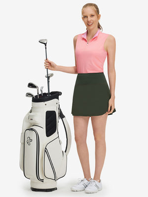 Front full body shot of model with golf gear wearing army green women's stretch a-line golf skort with 7 pockets