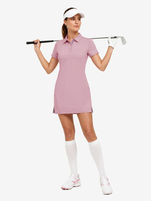 Front full body with golf club in pink of women's lightweight golf dress with 2 pockets.